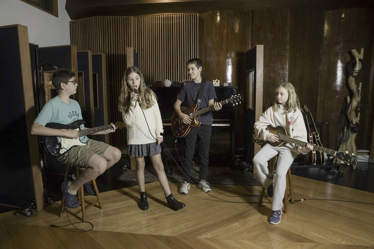 A student band performing together in the live room at South Creek