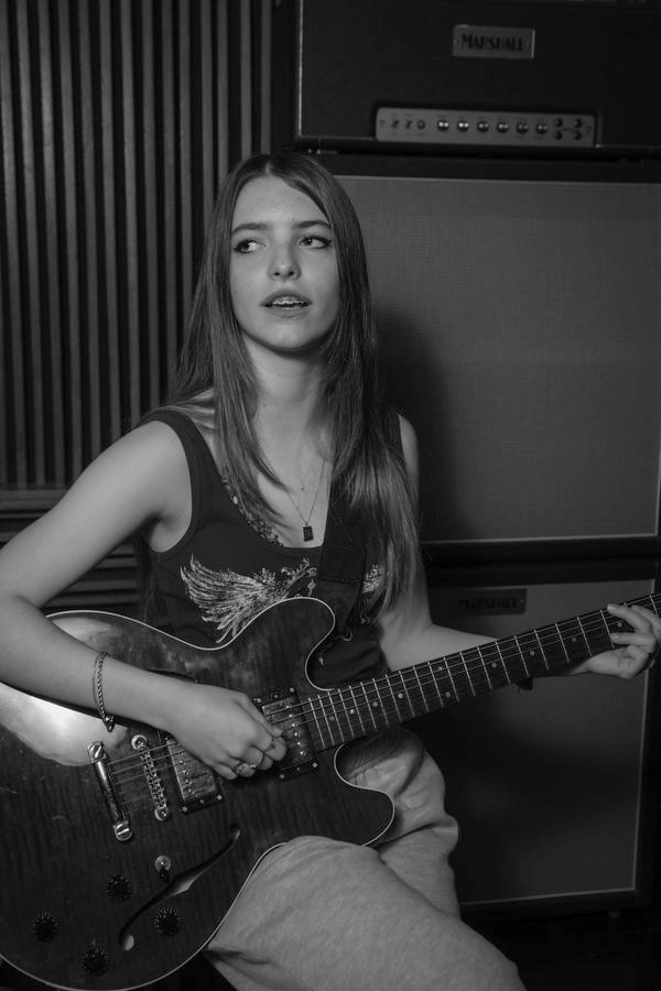 A student with an electric guitar